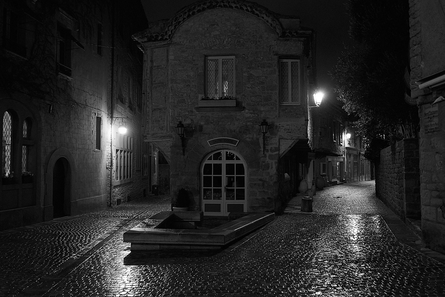 Night street view with wet coblestones after the rain in the fortress city of Carcassone in south France